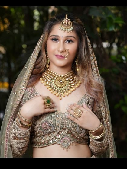 A full bridal look with our pastel green lehenga, complete with heavy gold and kundan jewellery.