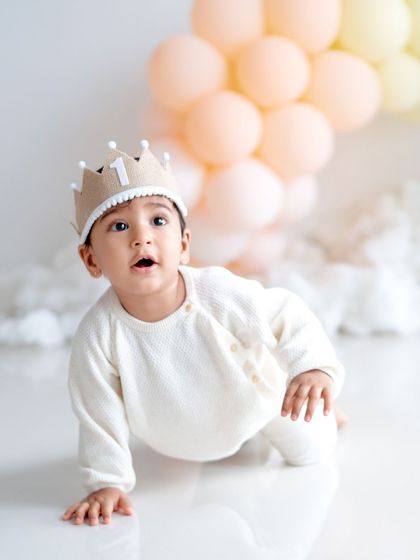 The birthday prince! A sweet shot of a baby boy in a "1" crown during his first birthday session.