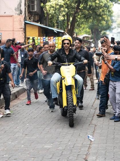 An action shot that tells a story. Varun Dhawan making a grand entrance on a motorbike for the 'Citadel Honey Bunny' launch, creating a memorable brand moment.