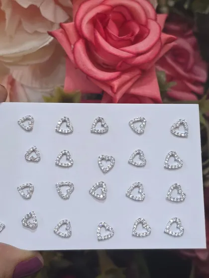A display of our delicate heart-shaped studs, perfect for a romantic and subtle look.
