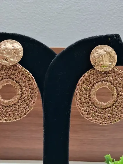 A different style of our brown crochet earrings, featuring a hammered gold stud. Each pair is made by our women artisans, making your purchase a gift that empowers.