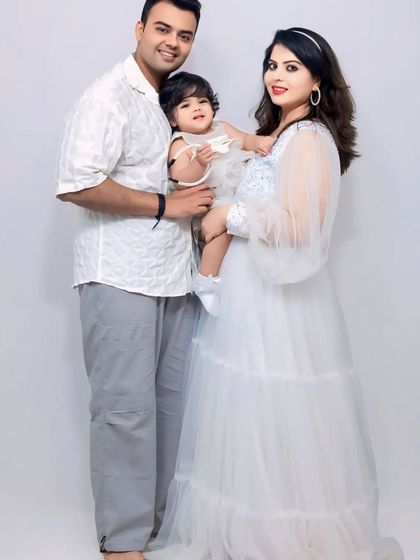 A beautiful family portrait. The mother is wearing my white sequin flare gown, which we've coordinated with a matching white dress for her daughter.