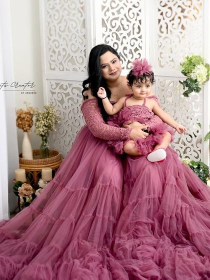 A mother and daughter twinning in gorgeous mauve gowns. This portrait is the epitome of elegance and showcases the special bond they share.