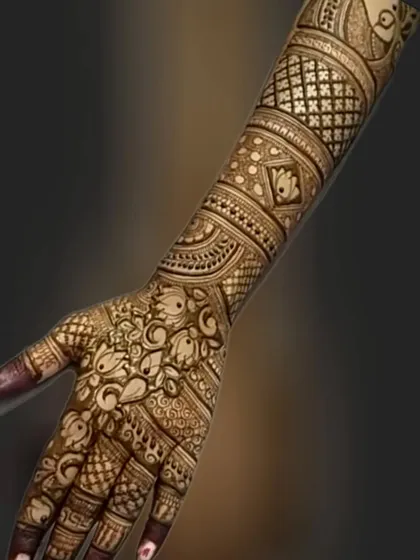 A single arm view of a full bridal design, showing the combination of lotus motifs, jaali work, and paisley elements.