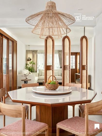 A featured image of the refurbished dining table, highlighting the exquisite bamboo chandelier that hangs above, making a statement while adhering to the natural and earthy Japandi aesthetic.