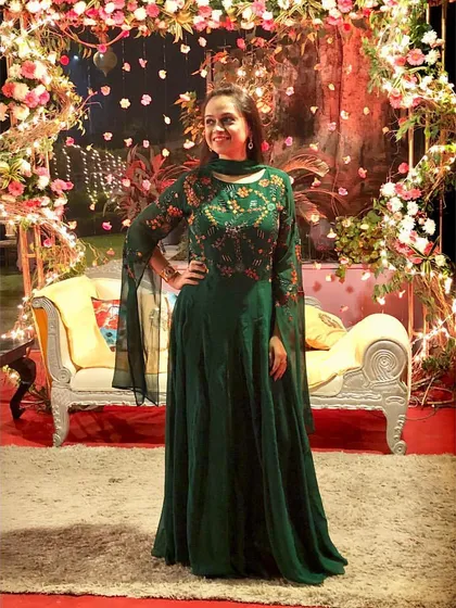 This elegant emerald green Anarkali gown is perfect for a wedding reception or sangeet. I chose this piece for its stunning color and trendy playful sleeves, which add a modern twist to a classic silhouette.