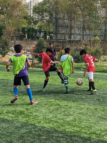 Close-quarters defending during the U10 friendly match, demonstrating the importance of tight marking.