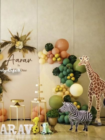 This modern and chic safari theme for Aarav's first birthday used a neutral color palette with pampas grass and gold accents. The life-sized giraffe and zebra props added a 'wow' factor to the decor.