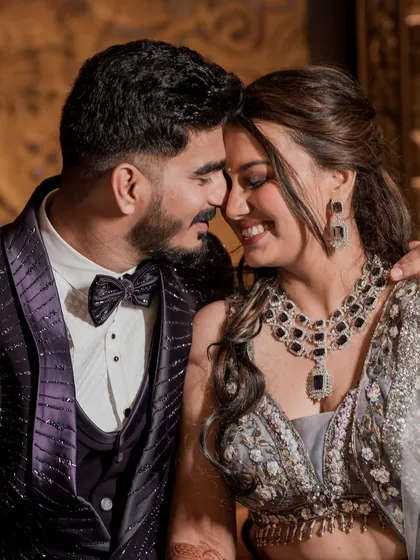 A tender moment between the couple. The soft lighting and their happy expressions make this a perfect reception portrait.
