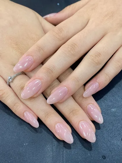 A perfect example of a simple, clean look. These are beautifully shaped, natural-looking extensions with a sheer pink gel polish for a healthy and polished appearance.