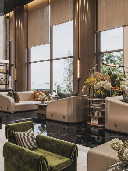 This view of the hotel lounge showcases the double-height windows and the elegant, custom-designed furniture.