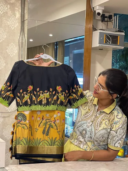 A glimpse into my love for designing and styling. Here I am holding a custom-stitched blouse designed to perfectly match the Pichwai-inspired digital print of the saree.