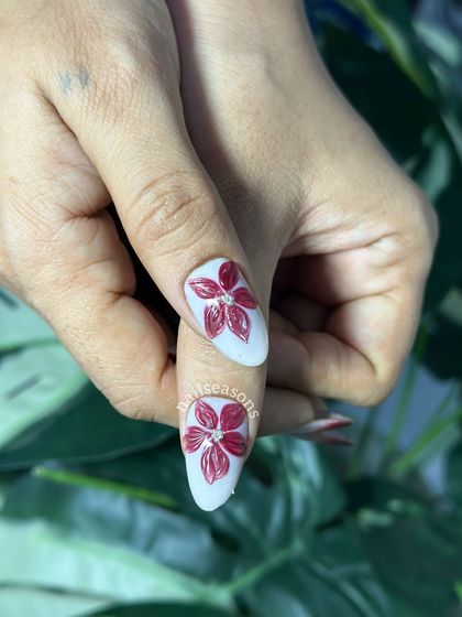 A close-up of these stunning 3D chrome flowers on a deep red ombre base.