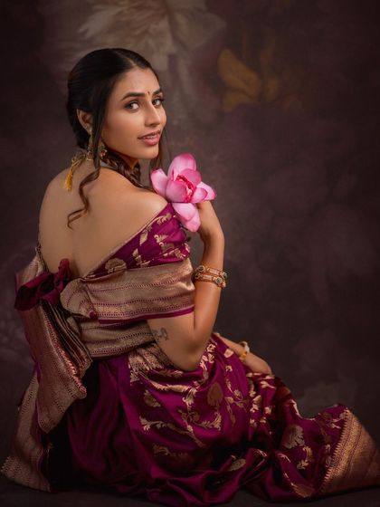 Another beautiful shot from the same series, where the rich texture of the saree and the soft lighting create a dreamy, romantic mood.