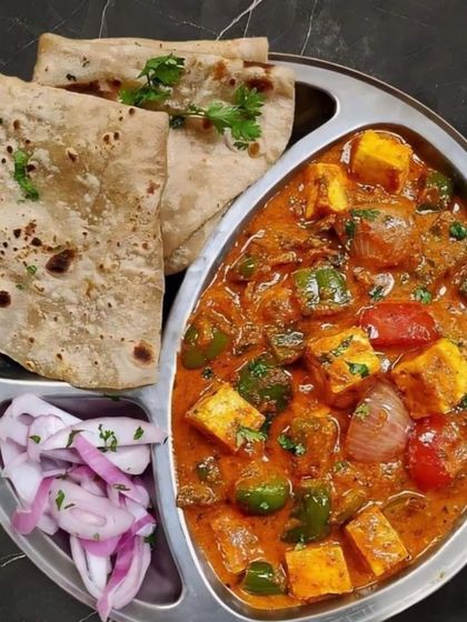 Another mini meal option featuring a hearty Kadai Paneer served with two parathas and a side of pickled onions. It's light, right, and perfectly satisfying.