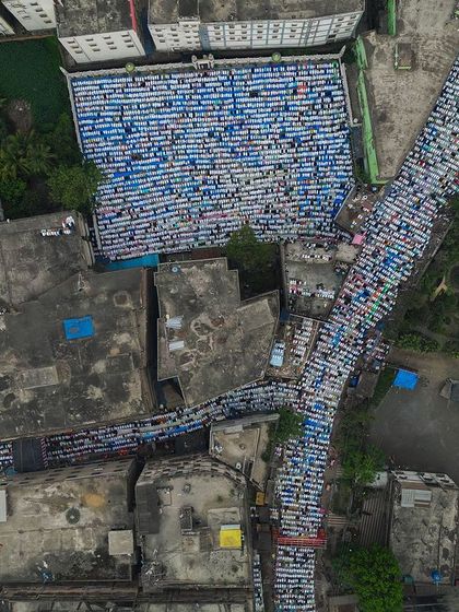 A top-down aerial view of Eid prayers in Kolkata. This angle shows how the streets and courtyards are completely transformed into a place of worship, showcasing incredible community discipline.