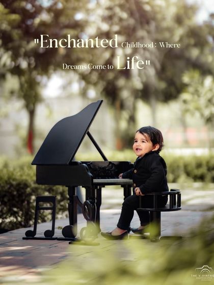 Enchanted childhood where dreams come to life. A smiling baby boy plays on a miniature grand piano in a beautiful, green park setting.