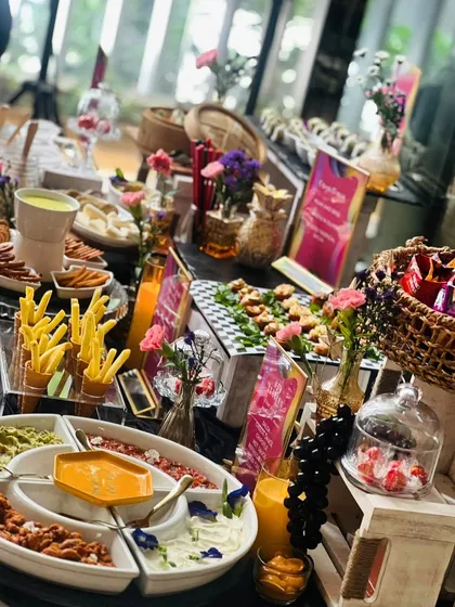 We created this fun and interactive snack table for a client's karaoke night. It features a unique Dorito’s DIY bar, sushi, dim sum, a Lebanese food board, and a gooey cheese fondue station for a truly memorable evening.