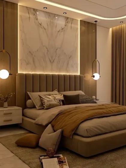 For this master bedroom, our goal was to create a warm and luxurious retreat. We achieved this with a rich color palette, a floor-to-ceiling upholstered headboard with marble and wood-paneled accents, and layered lighting from statement pendant lamps. The design focuses on creating a comfortable, elegant space for rest and relaxation.