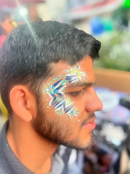 A graphic star design with blue and silver glitter. This is a great festival look for guys.