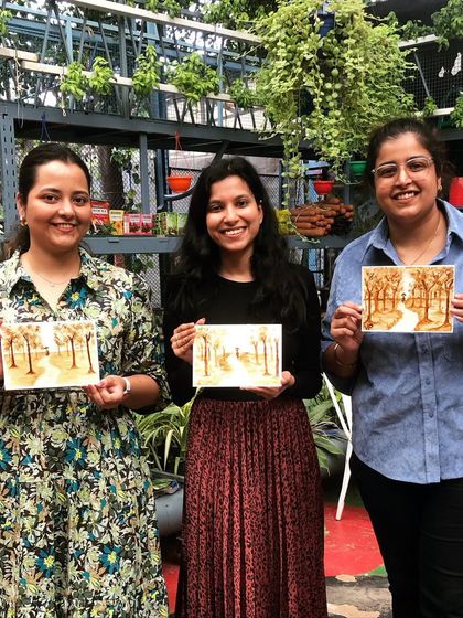More happy participants showing off their finished coffee paintings. The pride and joy on their faces is what makes these workshops so special.