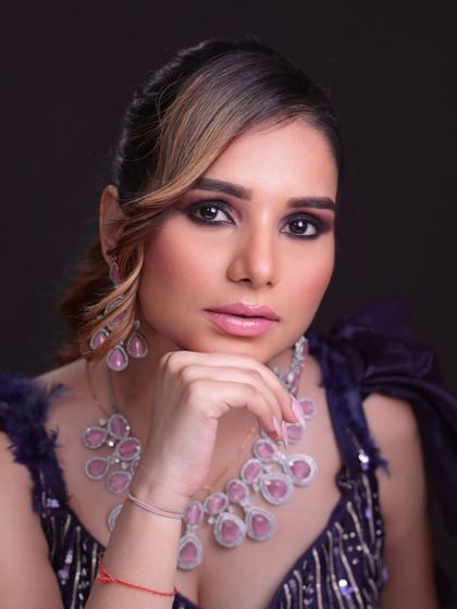 A glamorous reception look with smokey eyes and statement diamond and ruby jewelry.