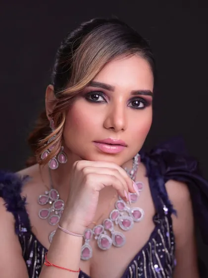 A glamorous reception look with smokey eyes and statement diamond and ruby jewelry.