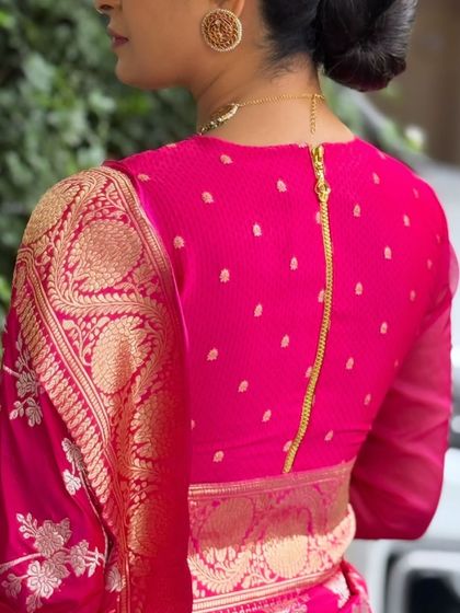 The back view of a client's high-neck pink blouse, featuring a modern full-length zipper. This shows how I incorporate contemporary details into traditional designs.
