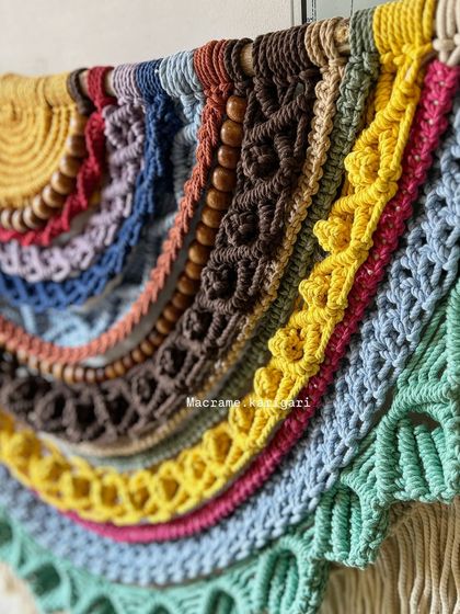 An even closer look at the detailed knotwork and wooden beads in our large rainbow wall hanging. Every layer adds a new dimension of color and texture.