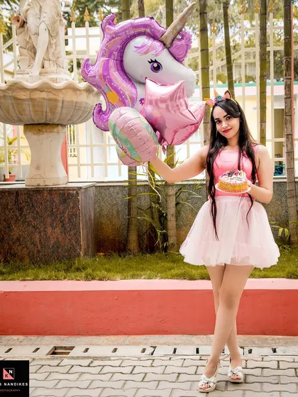 A fun and vibrant outdoor birthday shoot. The model holds a unicorn balloon and a small cake, showcasing my ability to capture celebratory moments with a playful and themed approach.