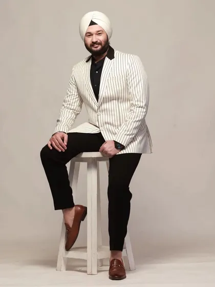 A modern take on formal wear. This white pinstripe blazer paired with black trousers is a stylish and sustainable choice for your next event.