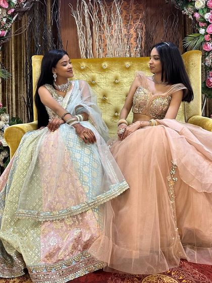 Sister goals. These two clients look beautiful in their complementary pastel lehengas, one in a multi-tonal sequin design and the other in a soft peach gown.