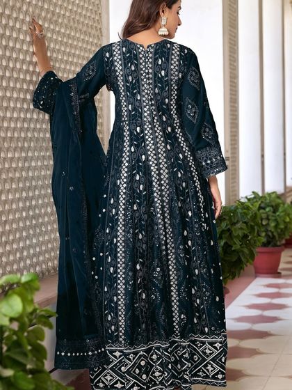 This navy blue Anarkali is all about grandeur. The heavy thread, zari, and sequence embroidery on the velvet fabric make it a truly royal outfit for a winter wedding.