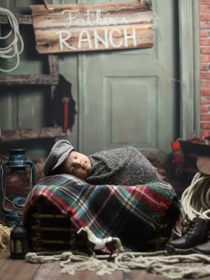 A creative ranch-themed rustic shoot. With a brick backdrop, ropes, and vintage western props, we can create a unique and personalized rustic look for your baby boy.