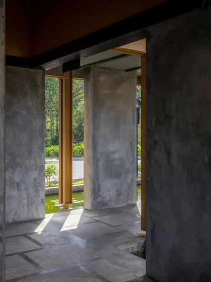 A corridor at the Teyla project, showcasing the interplay of light and shadow on the concrete walls.