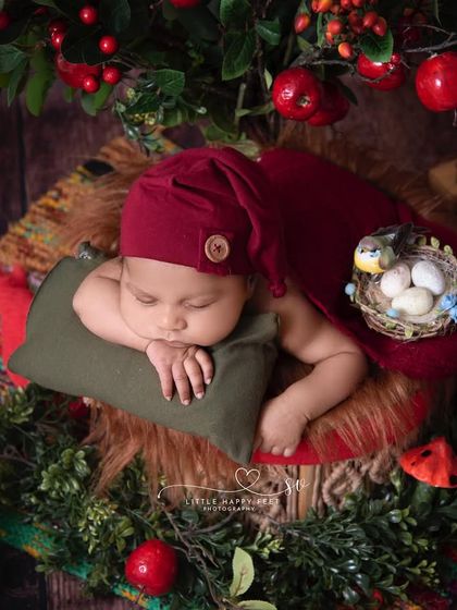 A little one under the apple tree. This setup, with its red apples and a bird's nest, has a wonderful, crisp, early-autumn feel.
