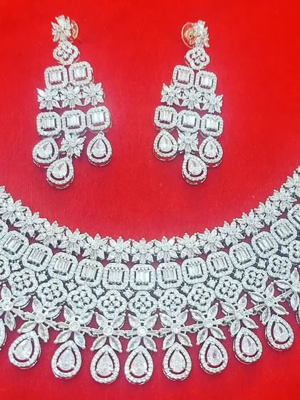 Get ready for your sangeet or cocktail night with this dazzling American Diamond necklace set. The rhodium polish gives it a brilliant, modern shine that will make you the center of attention on the dance floor.