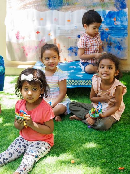 A group of friends proudly holding their creations after a fun session. The social aspect of my workshops is just as important as the activities themselves, helping children build friendships and learn to play together.