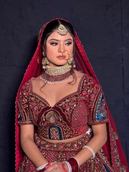 A profile view of the bridal look, highlighting the neatness of the updo and the placement of the maang tikka and nath.