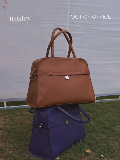 Introducing the Carryall, our ultimate 'giant tote' for when you need to carry it all. Stacked here in Pebbled Terra and Parisian Blue, these bags are designed for the modern woman who is never truly out of office and always in style.