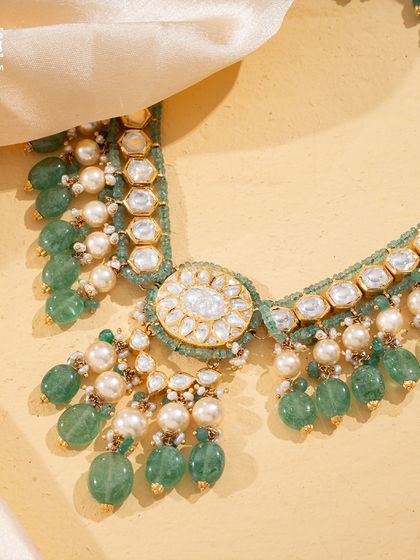 A close-up of the Tourmaline Trail, showing the interplay between the soft green tourmaline beads, lustrous pearls, and the central Polki diamond medallion.