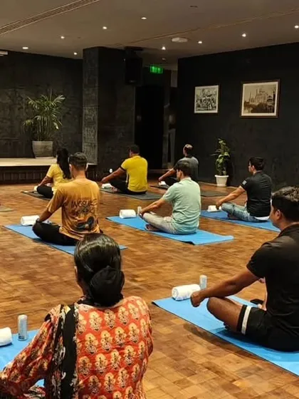Another angle from a corporate session, showing participants spaced out comfortably on their mats. Creating a safe and relaxing environment is my top priority for all employee wellness events.