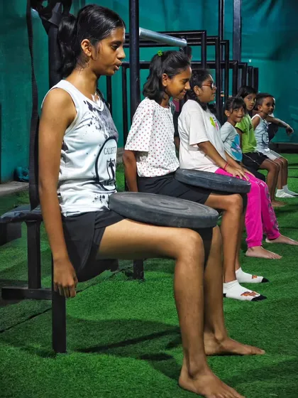Building leg and core endurance with wall sits. Our girls train together, motivating each other to hold on for just a little longer.