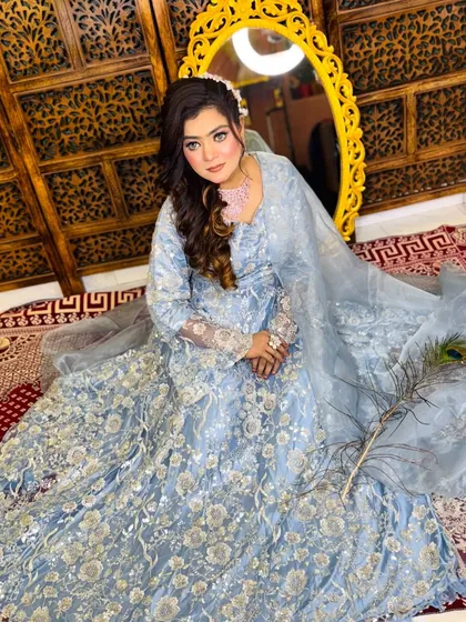 A full-length view of this gorgeous soft glam look. The light blue embroidered outfit is beautifully complemented by the subtle makeup and soft curls.