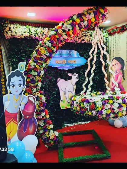 A full view of the Krishna-themed naming ceremony stage, including a speaker for music, showing how I provide a complete setup for your event.