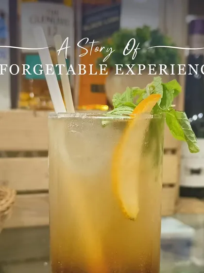 A refreshing long drink garnished with mint and an orange slice, telling a story of an unforgettable experience. This is what we strive to deliver in every glass.