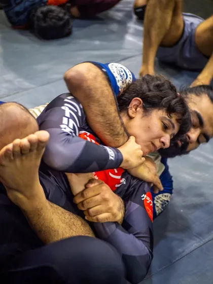 Strength has no gender. Our mats are a place of empowerment for everyone. Here, a female student practices submission wrestling techniques, proving that skill and determination are the ultimate equalizers in combat sports.