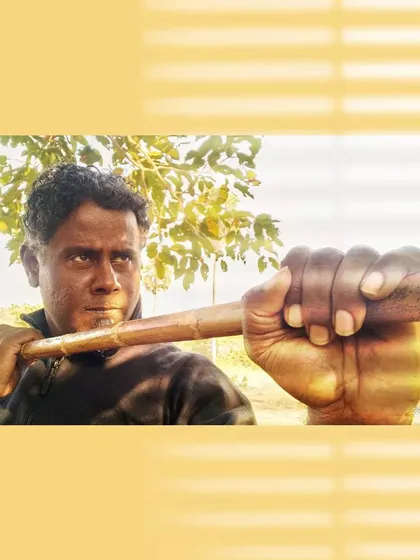 A close-up, intense shot with the Bo Staff, emphasizing the grip and readiness for action.