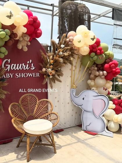 A detailed shot of the right side of the baby shower backdrop, highlighting the balloon garland, pampas grass, and cute elephant and teddy bear cutouts.