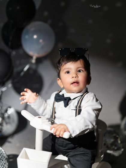 A cool little dude in a dapper outfit. The disco theme with dramatic lighting creates a fun and stylish portrait with a lot of personality.